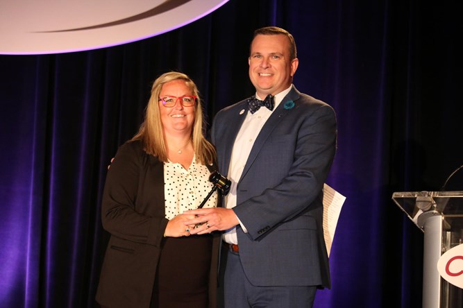 The passing of the presidential gavel is a CSC/CoSIDA tradition on the last day of each convention. Here, 2020-21 president Sam Atkinson (Gallaudet) with Potter, who was 2021-22 president. This was a reenactment at the 2022 in-person convention as the 2021 convention was virtual, due to COVID.